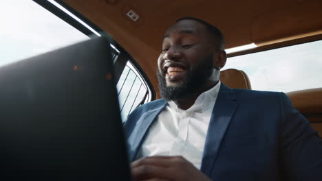 Primer-Hombre-De-Negocios-Africano-Aplaudiendo-En-El-Coche.-Hombre-Hablando-Por-Videollamada-En-El-Auto