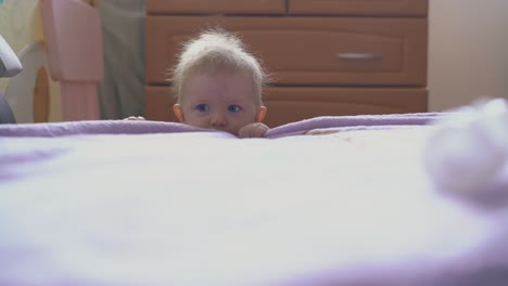 playful boy plays with plastic tube of medical tool at bed