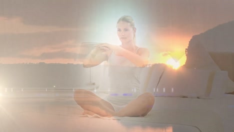 animation of landscape over caucasian woman practicing yoga and meditating