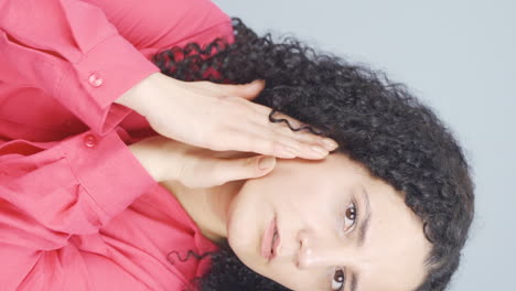 Vertical-video-of-Young-woman-with-wrinkles-and-problems-on-her-skin-is-unhappy.