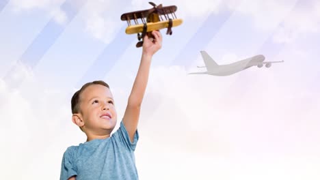 animation of happy caucasian boy playing with plane toy over silhouette of plane