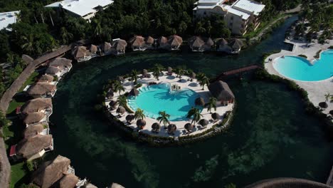 aerial view of luxury bungalows in a tropical lagoon with central swimming pool