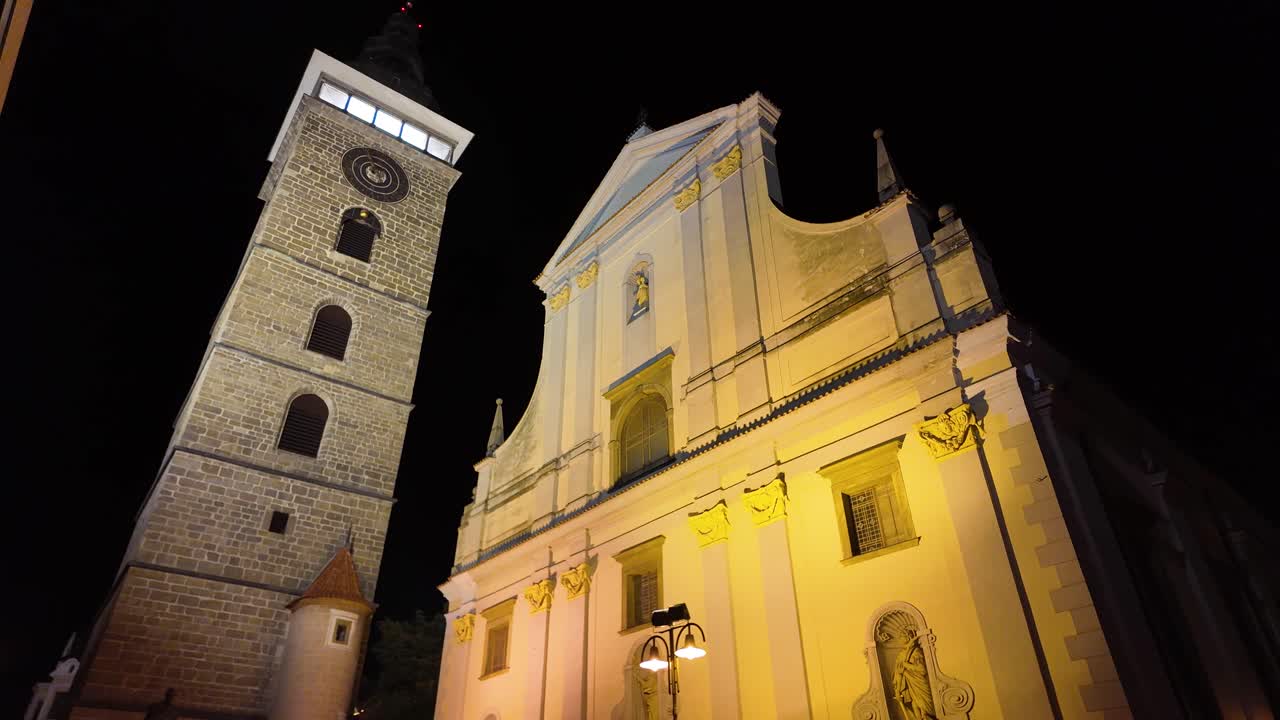 Night view of The Cathedral of St Nicholas, a remarkable Roman Catholic cathedral in České Budějovice, Czech Republic. Tilt Up Shot