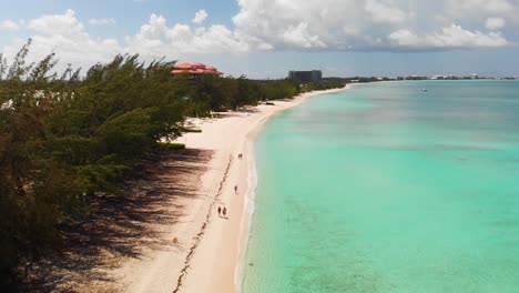 drone flying near 7 mile beach on a sunny day with turquoise waters