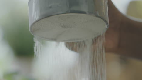 sifting flour into bowl