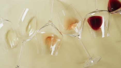 glasses with red and white wine lying on beige surface