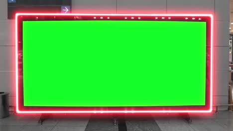 empty blank widescreen billboard with green screen, alpha channel. chroma key frame on airport hall, big banner for marketing.