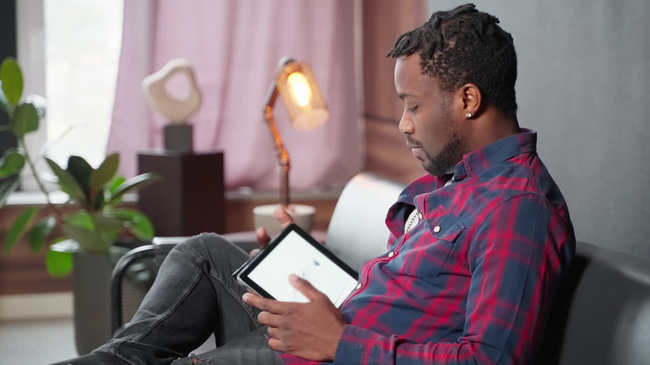 Man using a tablet on a couch