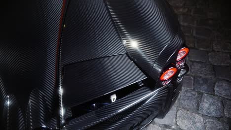 italian full carbon sport car rear detail in the dark