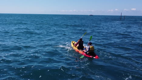 two people kayaking in the ocean