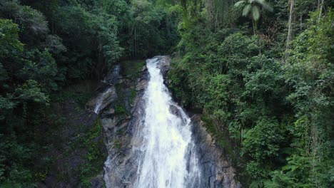 drone moves up, showing a beatifull waterfall