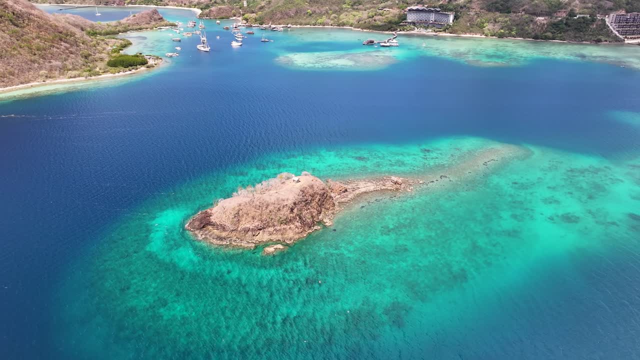 Beautiful coastal of Flores, Labuan Bajo with colourful waters and hilly landscape. Aerial