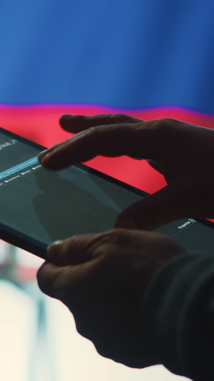 Close-up of Hands Scrolling Code on a Digital Tablet