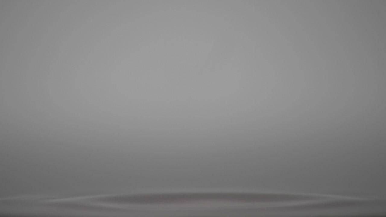 Orange Color Droplets Bounce On The Surface With Clear Water - Closeup Shot