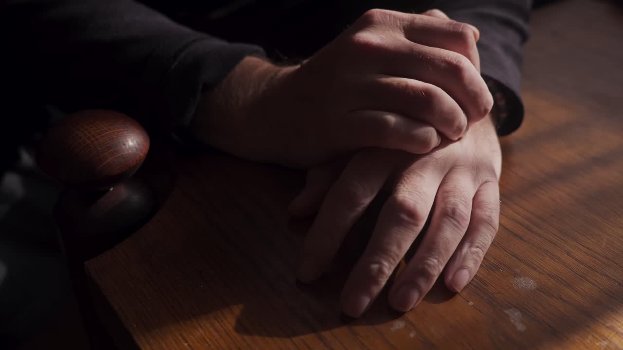 Nervous person hand fidgeting gestures and finger tapping in dark room