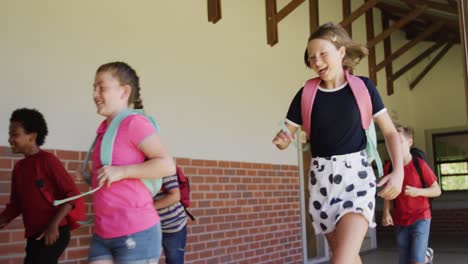 group of kids running in the school corridor