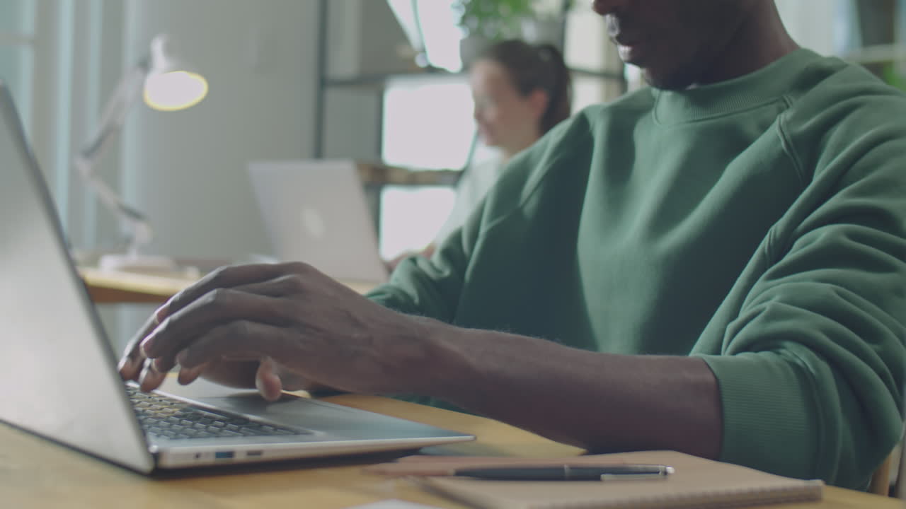 African American Man Working on Laptop in Office