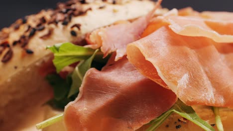 bagel sandwich brunch, lunch plate of a bagel with smoked salmon and cream cheese and ham, close up morning cafe menu.