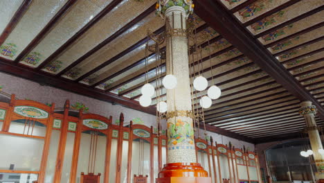 column with modernist decoration lights inside the nord train station in valencia, spain