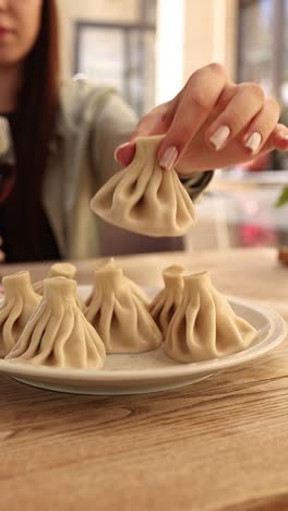 woman eating khinkali