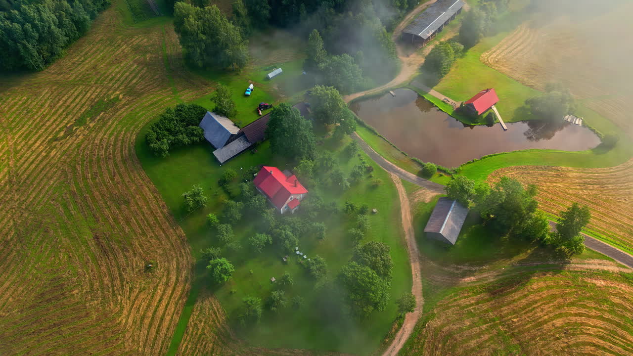 Aerial View of a Serene Farm in the Foggy Morning