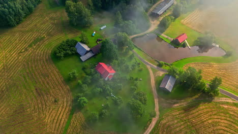 aerial view of a serene farm in the foggy morning