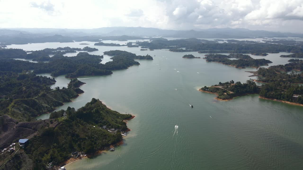 Aerial high angle of Guatapé lake and surrounding landscape, emphasizing natural beauty and calm waters