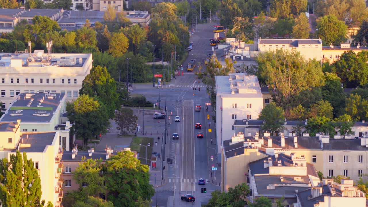Summer sunset over warsaw’s obozowa street with trams and cars, aerial