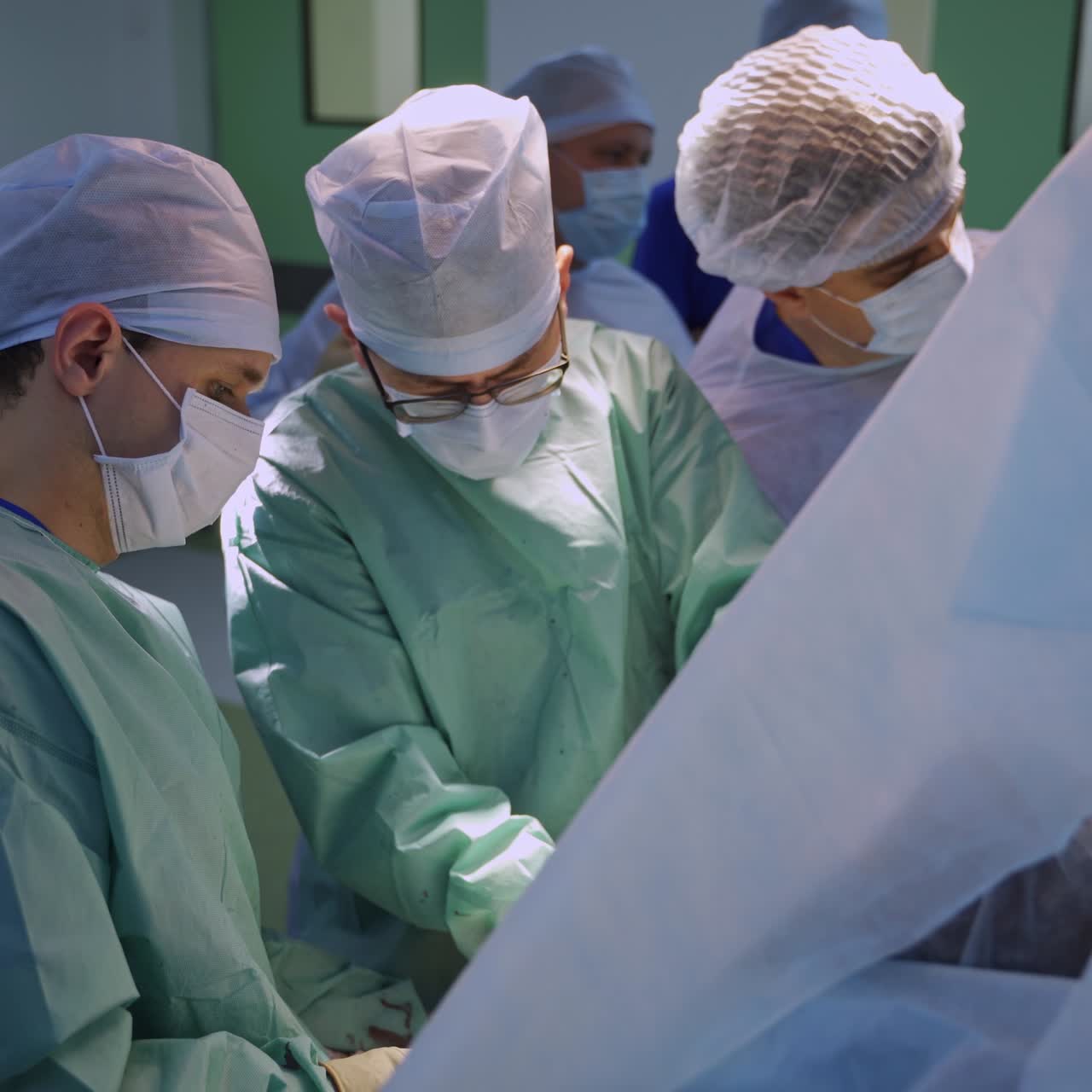 Co working surgery specialist performing operation. Working hard doctors helping each other during surgery on one patient