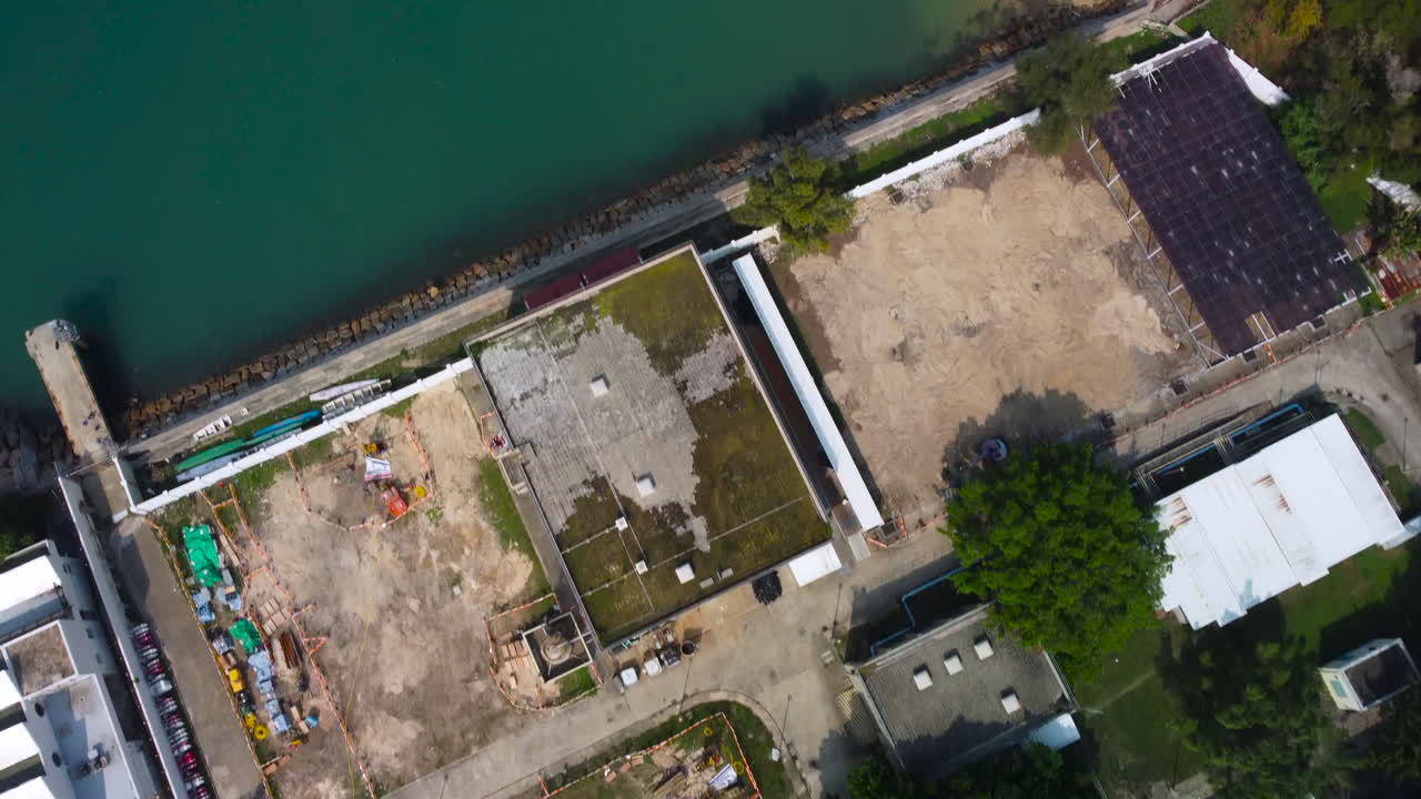 Ariel Bird View Drone dolly push in over factory Cheung Chau Island, Hong Kong. Revealing seashore beach fishing boat factory.
