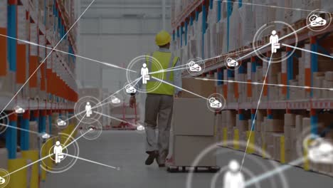 Network-of-digital-icons-against-rear-view-of-senior-male-worker-pulling-a-pallet-at-warehouse