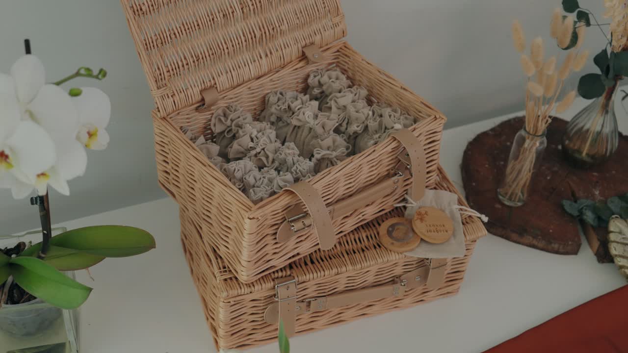 woven box with fabric pouches and natural decor for wedding guests