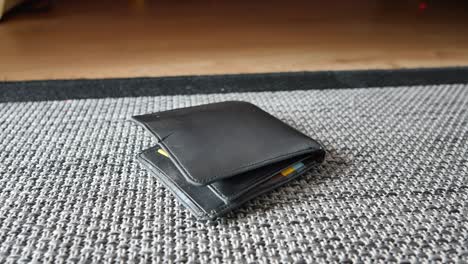 lost black leather wallet on carpet