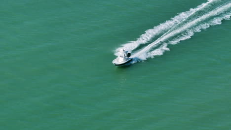 high speed fishing boat riding fast on florida waves on a sunny day