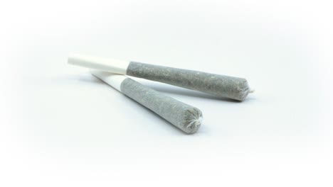 cannabis joints close-up rotating on an isolated white background