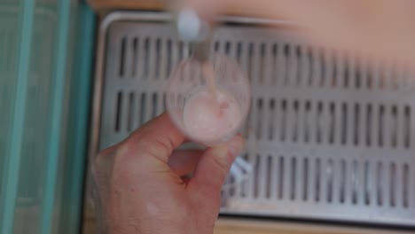 hand pouring drink into wine glass at wedding reception. overhead shot