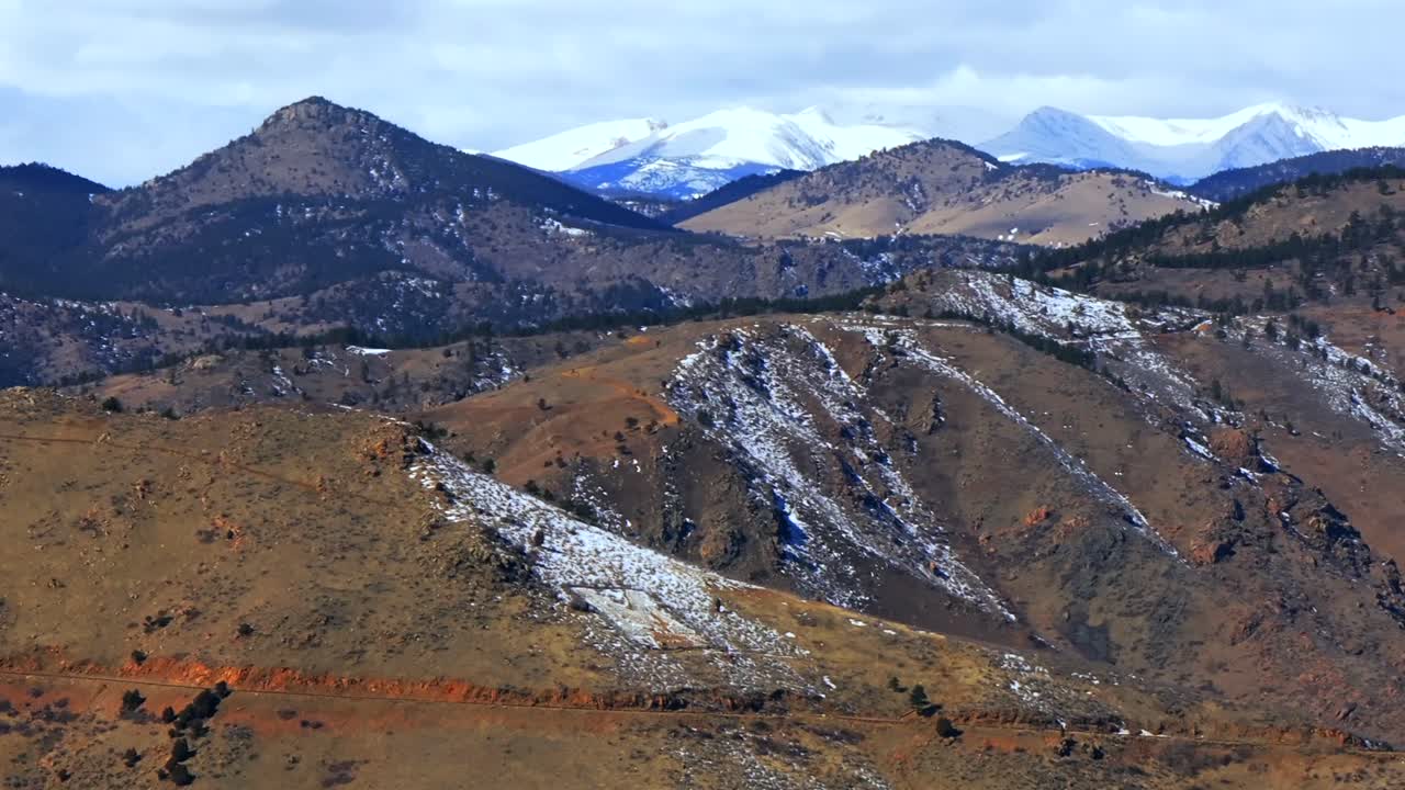Snowy Lookout Mountain windy road Genesse Morrison Golden Evergreen aerial drone view Colorado power line towers winter sunny morning afternoon Buffalo Bills Grave blue sky clouds circle right motion