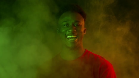 happy man in colorful smoke