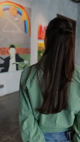 woman viewing art in an art gallery