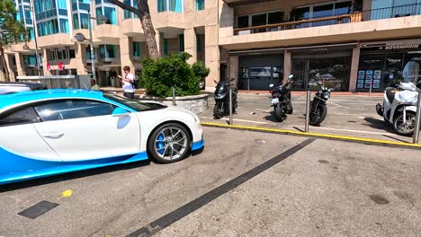 a luxury car passes by yachts in monaco