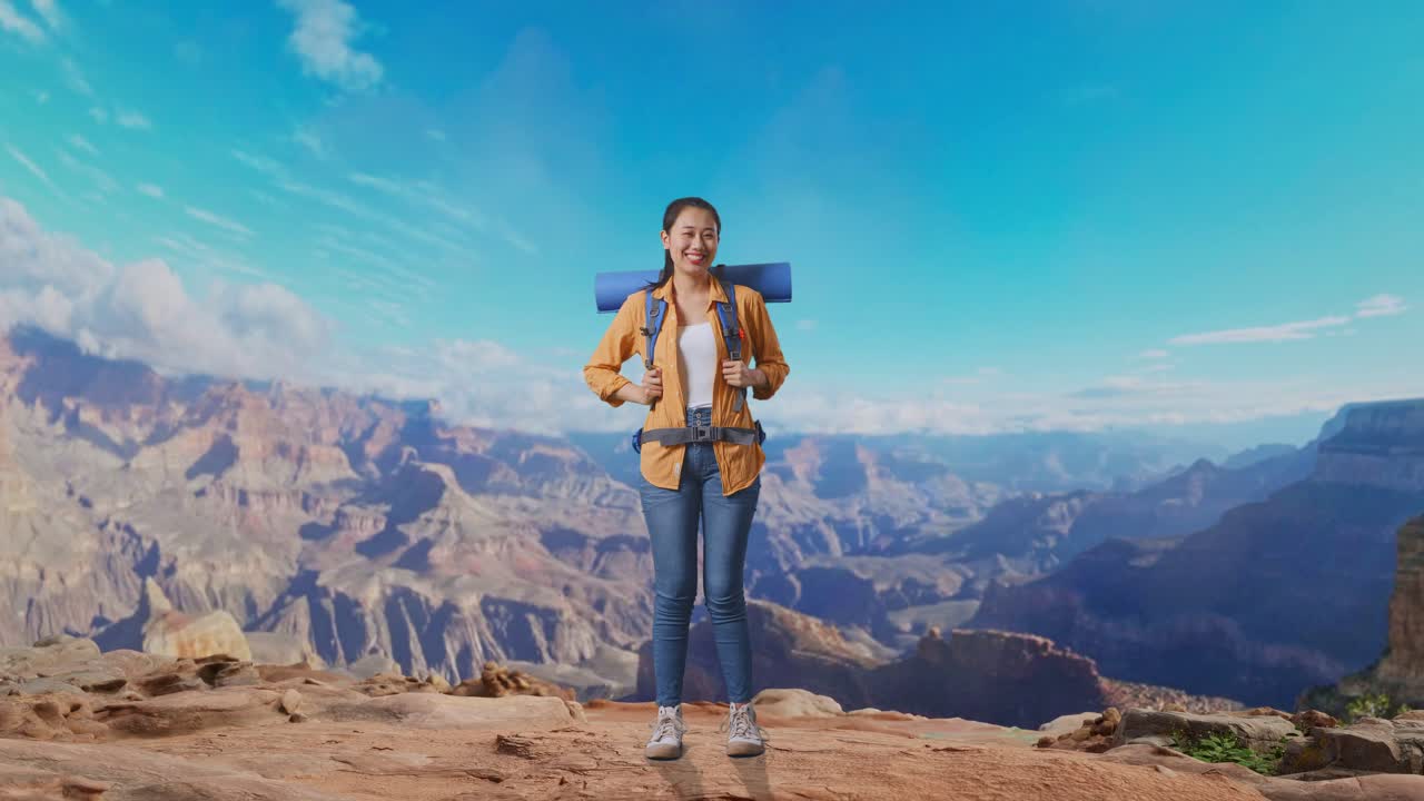 Full Body Of Asian Female Hiker With Mountaineering Backpack Smiling To Camera While Traveling At The Top Of Mountain