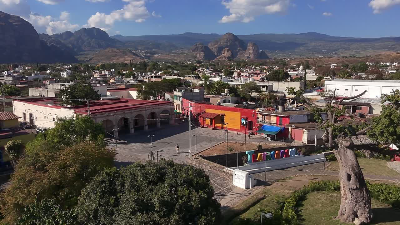 Oaxtepec and Tlayacapan, Morelos, Mexico, featuring a plaza, historic buildings, and mountain views. Drone aerial