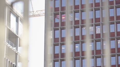 view behind gate of oslo new government quarter construction site, rack focus