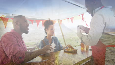 composite of happy african american couple buying takeaway food, and mountain countryside