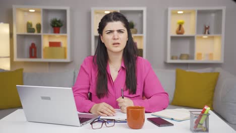 Home-office-worker-woman-looking-nervously-at-camera.