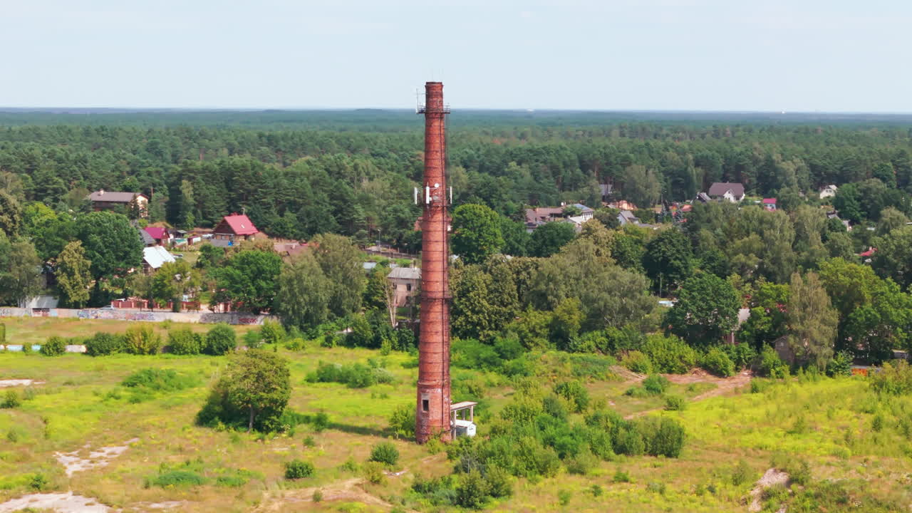 Old Brick Chimney Repurposed as Communication Tower in a Rural Landscape