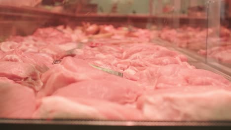 a meat shop specializing in fresh products. the scene shows neatly arranged meat on display counters, showcasing high-quality cuts in a clean and professional retail environment