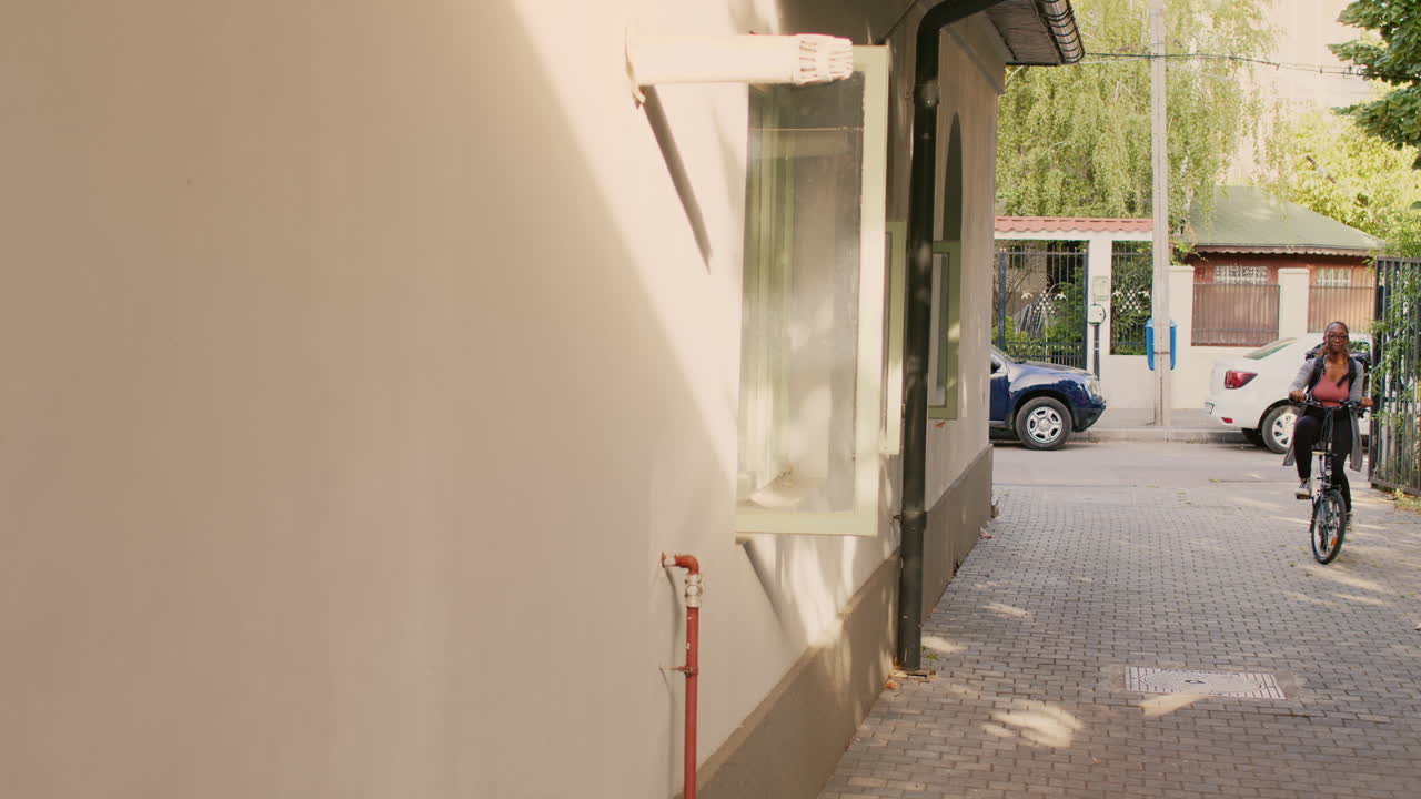 Woman Riding Bicycle on City Street