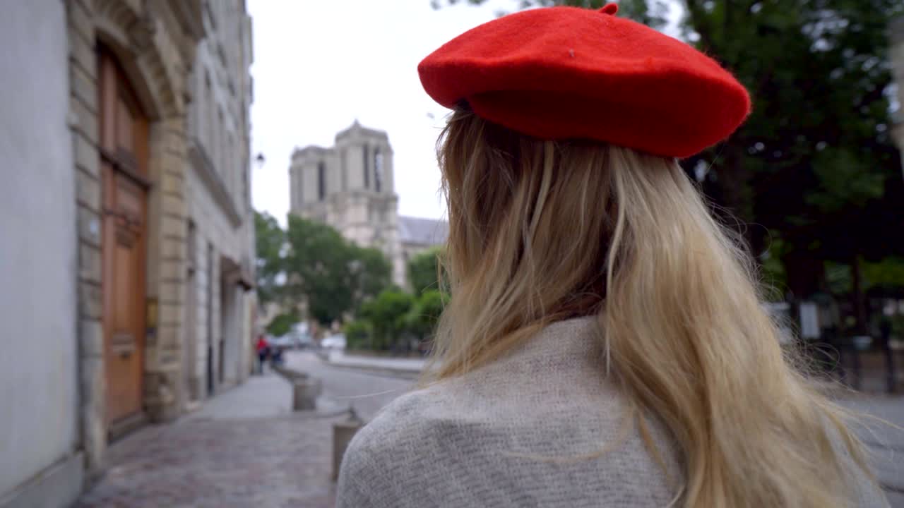 mujer joven vagando por parís viajando por la ciudad contemplando la catedral de notre dame de parís en primavera 4k