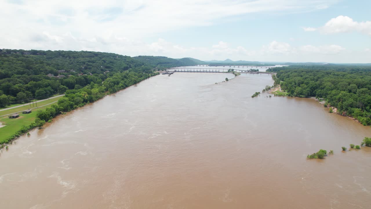 Aerial footage of Arkansas river in Little Rock Arkansas. Camera is heading approximately west toward the Big Dam Bridge